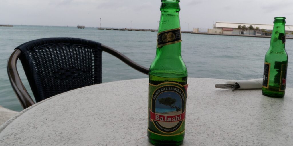 Balashi beers on a stone table, casual seaside setting in Oranjestad, Aruba