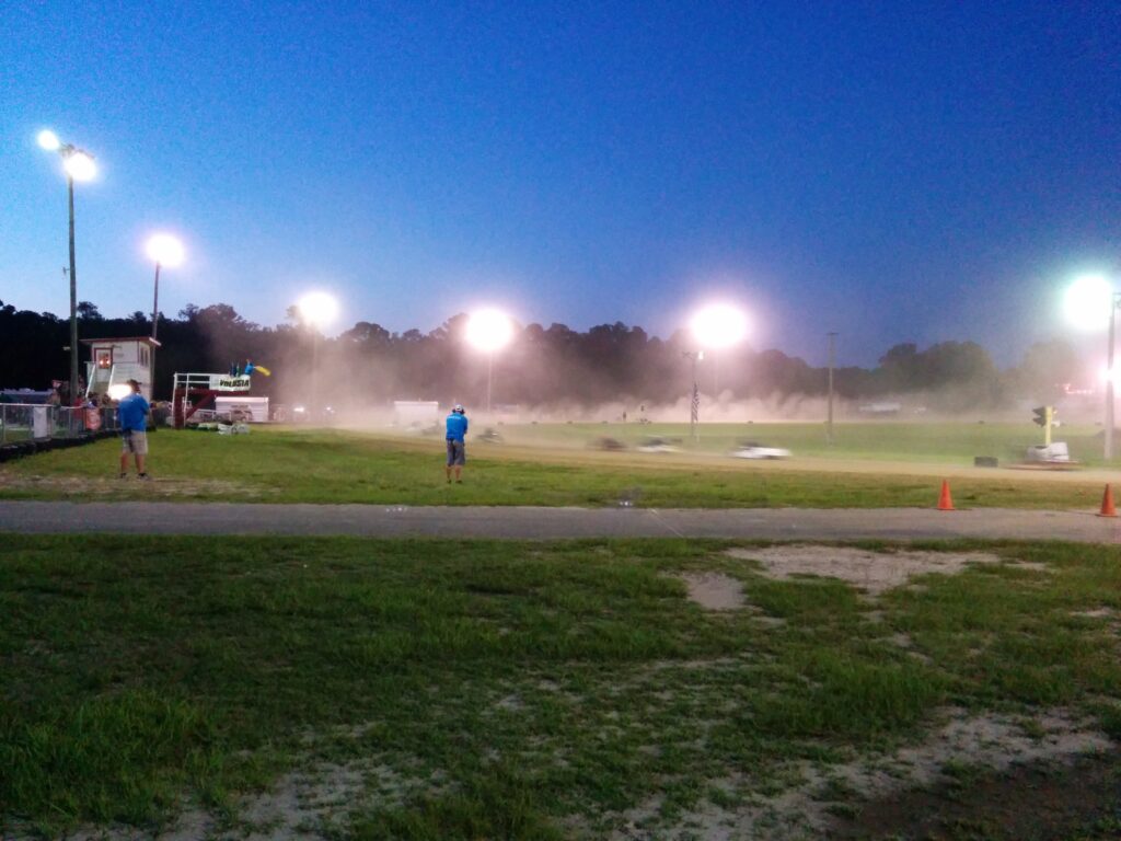 Misty evening at Volusia Speedways illuminated sports field with lone player.