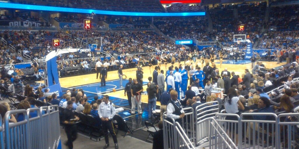 Huddle Time at Warriors vs. Magic NBA Game in Packed Indoor Basketball Arena