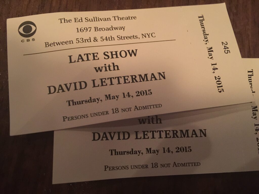 David Lettermans Late Show finale tickets from 2015 on dark table.